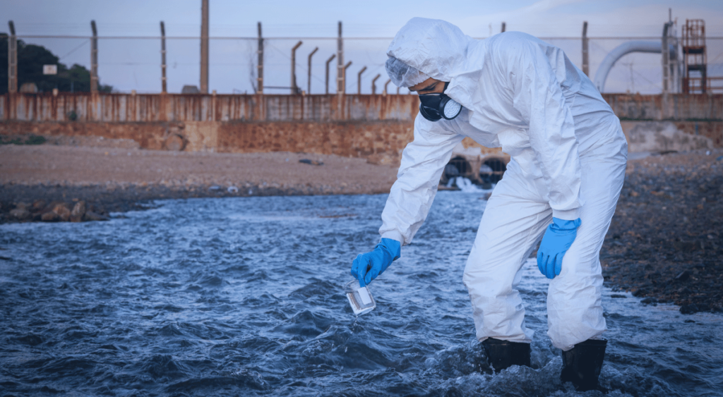 A man carefully tests a water sample, examining it closely. This represents the investigation into the contaminated drinking water at Camp Lejeune, which exposed service members and residents to harmful chemicals, leading to serious health concerns.