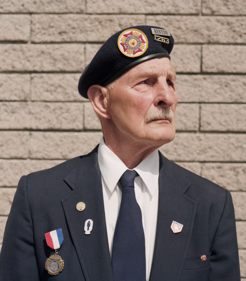 A determined U.S. Army veteran in uniform, reflecting on service years.