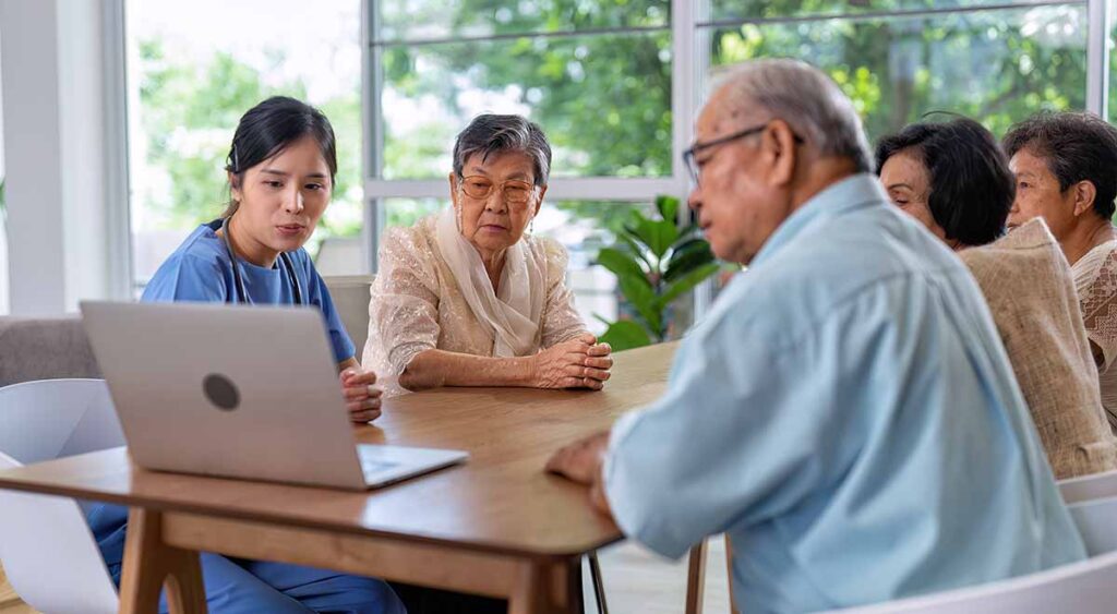 In the photo, a group of senior veterans listens intently, pens in hand, jotting down notes. Their focus reflects a shared goal: being fully prepared.