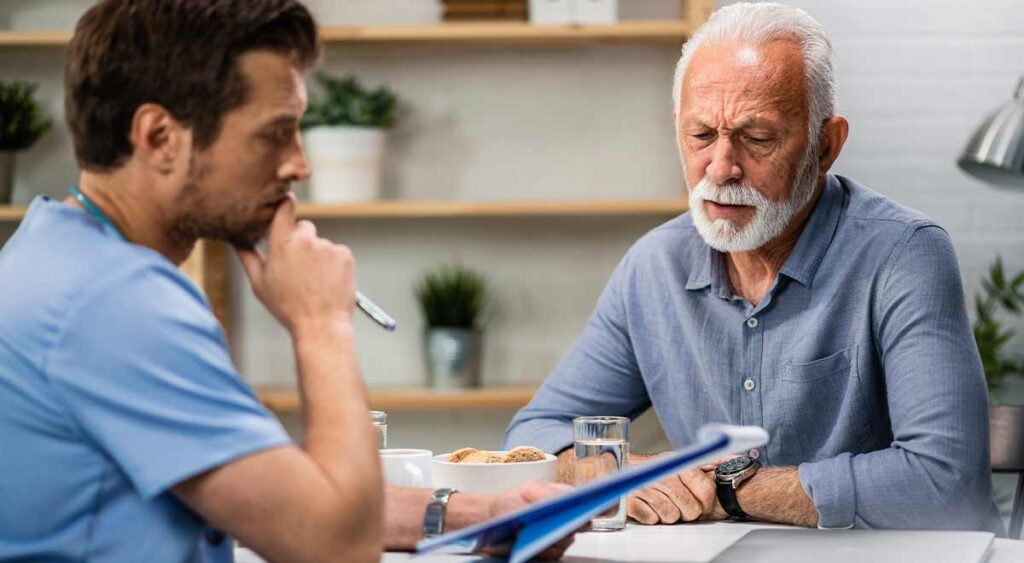 A doctor speaking with a veteran shows the personal side of an Independent Psychological Examination — a conversation that helps assess mental health for a VA claim.