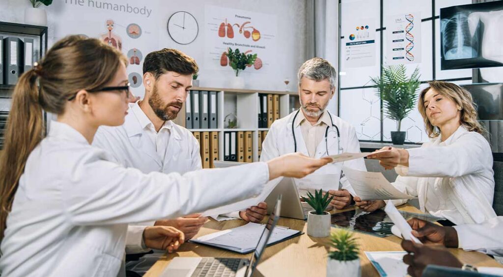 A medical team huddling represents the collaborative support system—like buddy statements and lay evidence—that strengthens a veteran’s claim by providing personal insight into their condition.