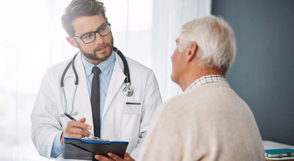 A photo of an Attain Med Group professional with a veteran shows their personalized, attentive care—key to creating strong, individualized reports.