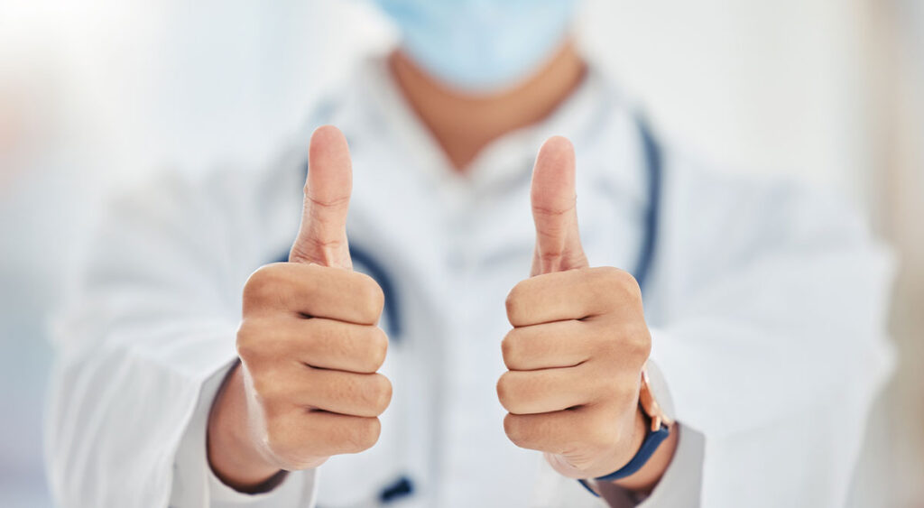 A doctor gives a thumbs up—symbolizing confidence and progress—as a veteran pursues a Higher-Level Review (HLR) for their VA claim.