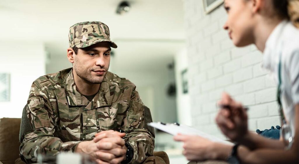 A veteran speaking with a psychologist represents the power of seeking specialized, independent care.