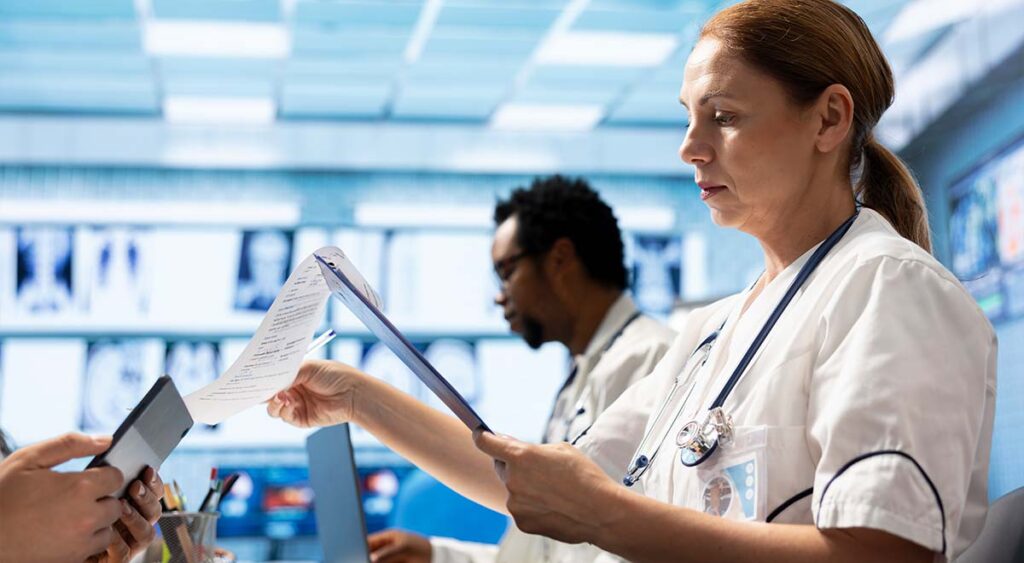 A photo of doctors meeting to discuss healthcare records reflects the collaborative effort behind reviewing medical evidence—an essential part of the VA claim process.