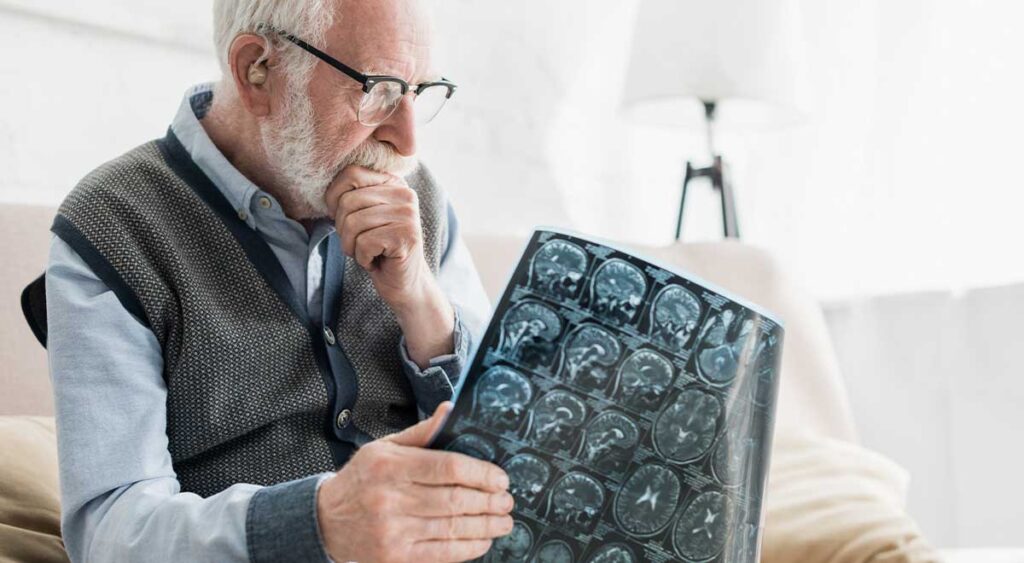 A veteran examines an X-ray, seeking clarity on the source of his symptoms.